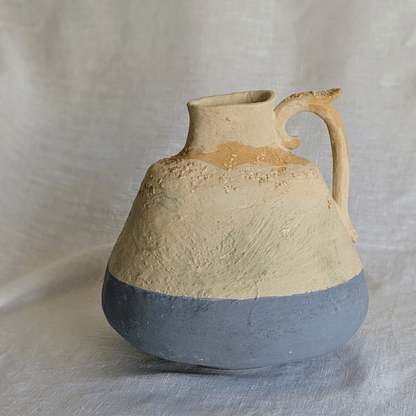 Pieza artesanal de barro rojo con técnica de churro, decorada con engobes y óxidos metálicos en tonos azul, blanco y terroso